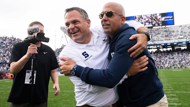 Penn State Athletic Director Pat Kraft hugs football coach James Franklin following a win over Indiana in 2023.