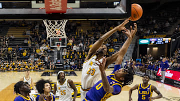 Jan 7, 2025; Columbia, Missouri, USA; Missouri Tigers guard Aidan Shaw (23) and LSU Tigers guard Vyctorius Miller (0) fight for a rebound during the second half at Mizzou Arena. Mandatory Credit: Jay Biggerstaff-Imagn Images
