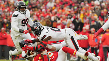 Jan 18, 2025; Kansas City, Missouri, USA; Kansas City Chiefs quarterback Patrick Mahomes (15) is sacked by Houston Texans linebacker Azeez Al-Shaair (top) and defensive tackle Tommy Togiai (72) during the first quarter of a 2025 AFC divisional round game at GEHA Field at Arrowhead Stadium. Mandatory Credit: Jay Biggerstaff-Imagn Images