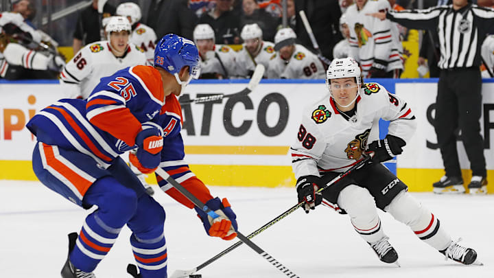 Chicago Blackhawks forward Connor Bedard (98) looks to make a pass in front of Edmonton Oilers defensemen Darnell Nurse (25)