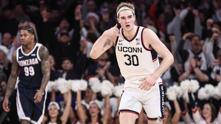 Dec 14, 2024; New York, New York, USA;  Connecticut Huskies forward Liam McNeeley (30) gestures after scoring in the second half against the Gonzaga Bulldogs at Madison Square Garden. Mandatory Credit: Wendell Cruz-Imagn Images