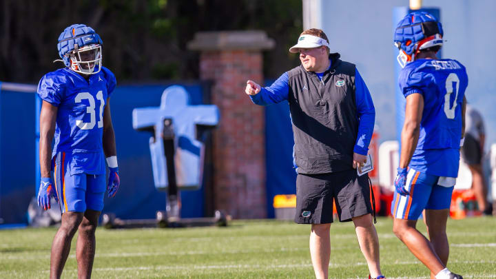 Florida Gators defensive coordinator Austin Armstrong coaches Florida Gators defensive back Ahman Covington (31) and Florida Gators defensive back Sharif Denson (0) during University of Florida Gators    Spring football practice at Sanders Practice Fields in Gainesville, FL on Tuesday, March 19, 2024. [Doug Engle/Gainesville Sun]