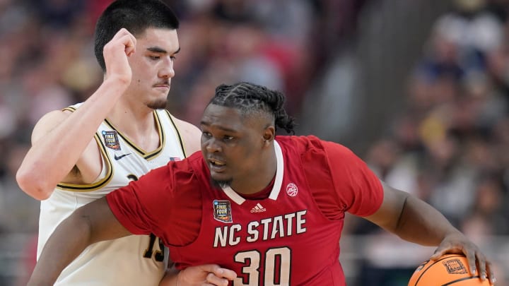 Purdue Boilermakers center Zach Edey (15) defends North Carolina State Wolfpack forward DJ Burns Jr. (30) during the NCAA Men’s Basketball Tournament Final Four game, Saturday, April 6, 2024, at State Farm Stadium in Glendale, Ariz.