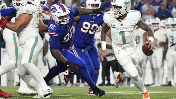 Sep 18, 2025; Orchard Park, New York, USA; Miami Dolphins quarterback Tua Tagovailoa (1) looks to pass against Buffalo Bills defensive tackle Daquan Jones (92) in the third quarter at Highmark Stadium. Sep 18, 2025; Orchard Park, New York, USA; Miami Dolphins quarterback Tua Tagovailoa (1) looks to pass against Buffalo Bills defensive tackle Daquan Jones (92) in the third quarter at Highmark Stadium.