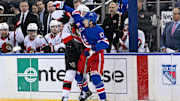 Jan 21, 2025; New York, New York, USA;  New York Rangers defenseman Will Borgen (17) and Ottawa Senators left wing Brady Tkachuk (7) collide along the boards during the third period at Madison Square Garden. Mandatory Credit: Dennis Schneidler-Imagn Images