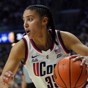 UConn guard Azzi Fudd drives the ball during a game.