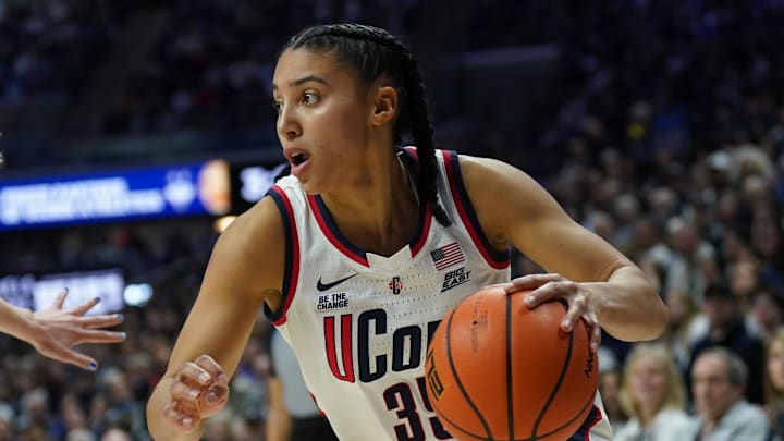 UConn guard Azzi Fudd drives the ball during a game. UConn guard Azzi Fudd drives the ball during a game.
