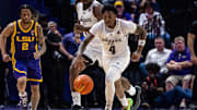 Mar 8, 2025; Baton Rouge, Louisiana, USA;  Texas A&M Aggies guard Wade Taylor IV (4) brings the ball up court against LSU Tigers guard Mike Williams III (2) during the second half at Pete Maravich Assembly Center. Mandatory Credit: Stephen Lew-Imagn Images