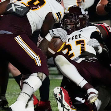 CoffeeÕs Tyrese Woodgett (27) drives in foe a touchdown during a GHSA 1st round high school football playoff game against Coffee in Hoschton, Ga., on Friday, Nov. 15, 2024.