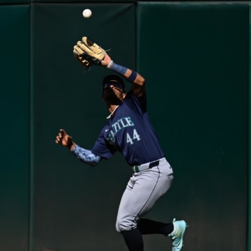 Seattle Mariners center fielder Julio Rodríguez catches a fly ball during a game against the Oakland Athletics on Monday at Oakland Coliseum.