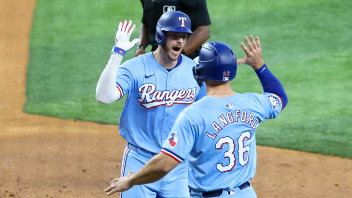 Jul 21, 2024; Arlington, Texas, USA; Texas Rangers catcher Jonah Heim (28) celebrates with Texas Rangers left fielder Wyatt Langford (36) after hitting a three-run home run during the fourth inning against the Baltimore Orioles at Globe Life Field. Mandatory Credit: Kevin Jairaj-USA TODAY Sports