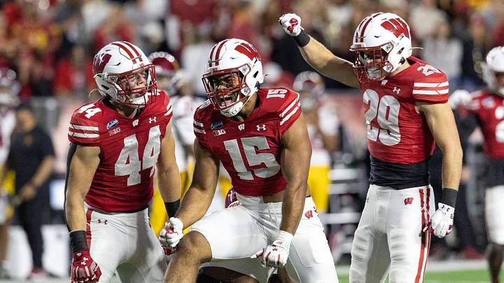 Oct 24, 2026; Madison, Wisconsin, USA;  Wisconsin Badgers outside linebacker Sebastian Cheeks (15) and linebacker Cooper Catalano (44) celebrate after tackling USC Trojans running back King Miller (8) as Wisconsin safety Matt Jung (29) joins the celebration during the first half at Camp Randall Stadium.  Mandatory Credit: Anthony Wahl-Imagn Images