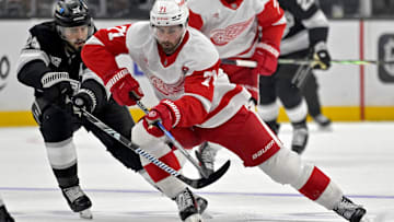 Nov 16, 2024; Los Angeles, California, USA; Detroit Red Wings center Dylan Larkin (71) controls the puck from Los Angeles Kings center Phillip Danault (24) in the third period at Crypto.com Arena. Mandatory Credit: Jayne Kamin-Oncea-Imagn Images