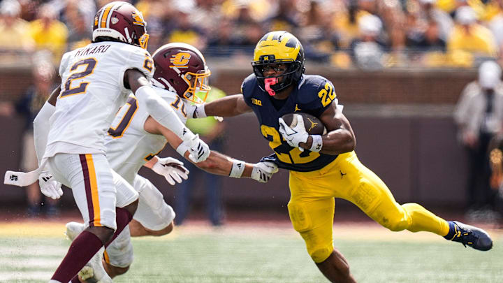 Michigan running back Justice Haynes (22) runs against Central Michigan defensive back Elijah Gordon (10) and defensive back Elijah Rikard (2) during the second half at Michigan Stadium in Ann Arbor on Saturday, Sept. 13, 2025.