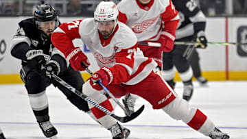 Nov 16, 2024; Los Angeles, California, USA; Detroit Red Wings center Dylan Larkin (71) controls the puck from Los Angeles Kings center Phillip Danault (24) in the third period at Crypto.com Arena. Mandatory Credit: Jayne Kamin-Oncea-Imagn Images