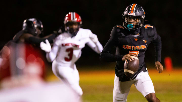 Hawthorne Hornets quarterback Cj Ingram (7) looks for an open receiver. The Hawthorne Hornets hosted the Blountstown Tigers at Hawthorne High School in Hawthorne, FL on Thursday, November 30, 2023 in the Class 1R State Semis Football. The Hornets defeated the Tigers 49-0 and advance to the State Championship game next Thursday in Tallahassee. [Doug Engle/Gainesville Sun]