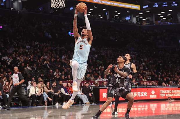 San Antonio Spurs guard Stephon Castle (5) drives past Brooklyn Nets guard Keon Johnson (45) for a dunk