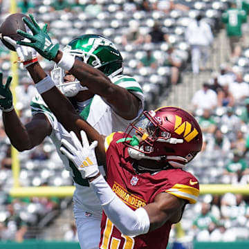 Aug 10, 2024; East Rutherford, New Jersey, USA; Washington Commanders cornerback Emmanuel Forbes (13) breaks up a pass to New York Jets wide receiver Mike Williams (18) during the first quarter at MetLife Stadium. Mandatory Credit: Lucas Boland-Imagn Images