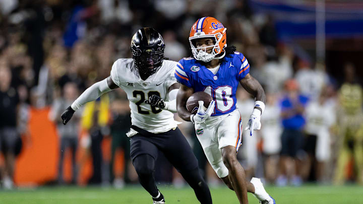 Oct 5, 2024; Gainesville, Florida, USA; Florida Gators wide receiver Tank Hawkins (10) runs with the ball past UCF Knights defensive back Mac McWilliams (20) during the first half at Ben Hill Griffin Stadium. Mandatory Credit: Matt Pendleton-Imagn Images