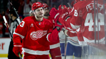 Apr 15, 2024; Detroit, Michigan, USA;  Detroit Red Wings right wing Alex DeBrincat (93) receives congratulations from teammates after scoring in the third period against the Montreal Canadiens at Little Caesars Arena. Mandatory Credit: Rick Osentoski-USA TODAY Sports