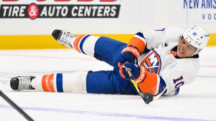 Mar 10, 2026; St. Louis, Missouri, USA; New York Islanders center Brayden Schenn (10) passes the puck as he falls to the ice during the third period against the St. Louis Blues at Enterprise Center. Mandatory Credit: Jeff Curry-Imagn Images