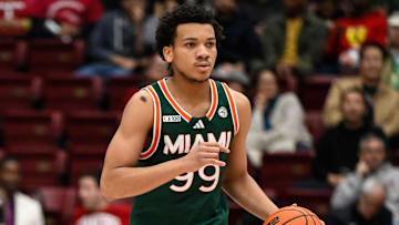 Jan 22, 2025; Stanford, California, USA; Miami (FL) Hurricanes guard Divine Ugochukwu (99) dribbles against the Stanford Cardinal in the first half at Maples Pavilion. Mandatory Credit: Eakin Howard-Imagn Images