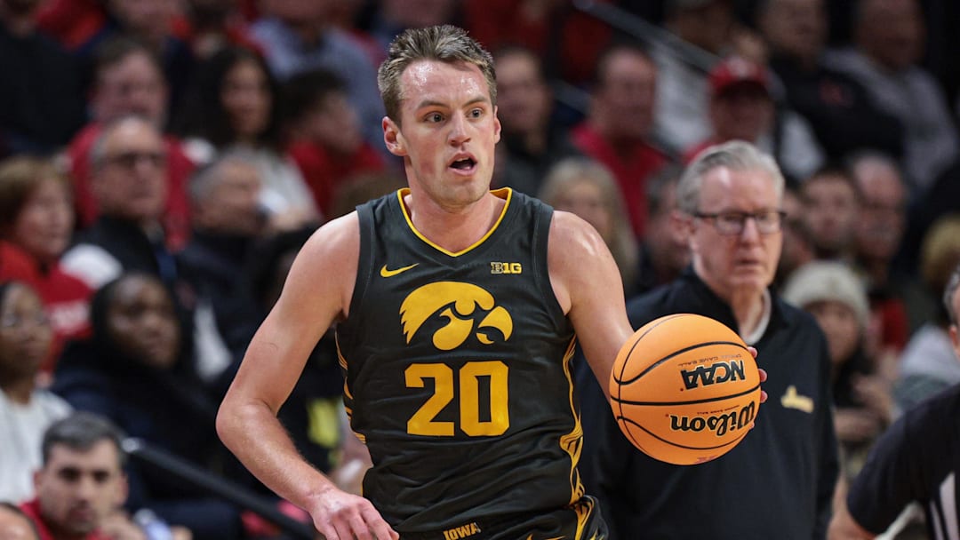 Feb 12, 2025; Piscataway, New Jersey, USA; Iowa Hawkeyes forward Payton Sandfort (20) dribbles up court during the first half against the Rutgers Scarlet Knights at Jersey Mike's Arena.