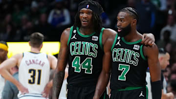 Former Boston Celtics center Robert Williams III (44) and current guard Jaylen Brown (7) talk during the second half against the Denver Nuggets at Ball Arena.