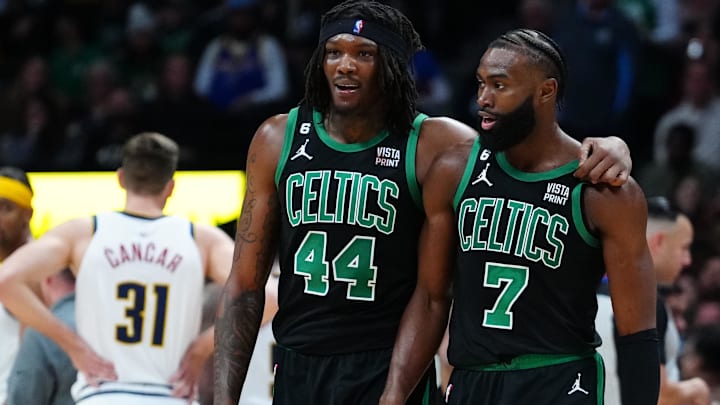 Former Boston Celtics center Robert Williams III (44) and current guard Jaylen Brown (7) talk during the second half against the Denver Nuggets at Ball Arena.