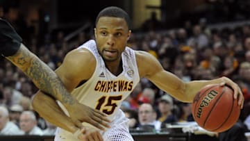 Mar 14, 2015; Cleveland, OH, USA; Central Michigan Chippewas guard Chris Fowler (15) dribbles the ball around Buffalo Bulls forward Justin Moss (23) during the first half of the championship game of the MAC Tournament at Quicken Loans Arena. Mandatory Credit: Ken Blaze-Imagn Images
