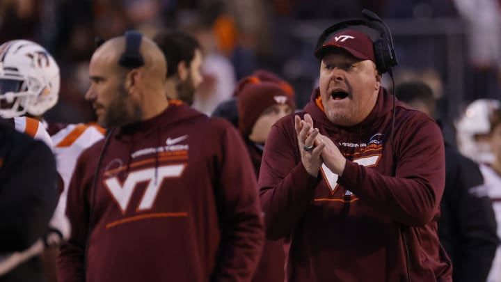 Nov 27, 2021; Charlottesville, Virginia, USA; Virginia Tech Hokies interim head coach J.C. Price (R) encourages his players from the sidelines against the Virginia Cavaliers during the second quarter at Scott Stadium. Mandatory Credit: Geoff Burke-USA TODAY Sports