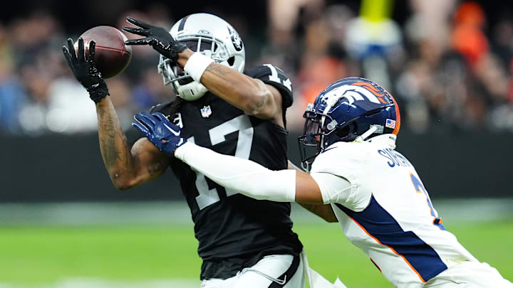 Las Vegas Raiders wide receiver Davante Adams (17) makes a catch against Denver Broncos cornerback Pat Surtain II (2) during the second quarter at Allegiant Stadium.