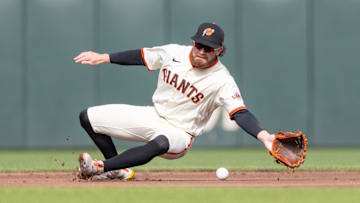 Jul 27, 2025; San Francisco, California, USA; San Francisco Giants second baseman Brett Wisely (0) knocks down the ball during the third inning against the New York Mets at Oracle Park. Mandatory Credit: Bob Kupbens-Imagn Images