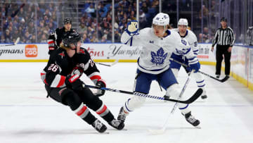 Mar 30, 2024; Buffalo, New York, USA;  Buffalo Sabres defenseman Rasmus Dahlin (26) watches as Toronto Maple Leafs right wing William Nylander (88) grabs the puck out of the air with his glove during the first period at KeyBank Center. Mandatory Credit: Timothy T. Ludwig-USA TODAY Sports