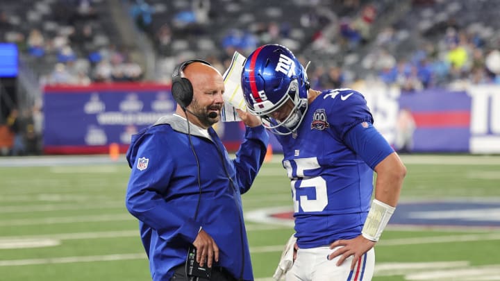 Aug 8, 2024; East Rutherford, New Jersey, USA; New York Giants quarterback Tommy DeVito (15) discusses the next play with New York Giants head coach Brian Daboll during the game against the Detroit Lions at MetLife Stadium.  