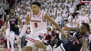 Arizona guard Jaden Bradley (0) fouls Wisconsin guard John Tonje (9) during the second half of their game Friday, November 15, 2024 at the Kohl Center in Madison, Wisconsin.