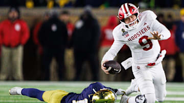 Notre Dame defensive lineman Loghan Thomas (10) tackles Indiana defensive back Jamier Johnson (9) during the first round of the College Football Playoff between Notre Dame and Indiana at Notre Dame Stadium on Friday, Dec. 20, 2024, in South Bend.