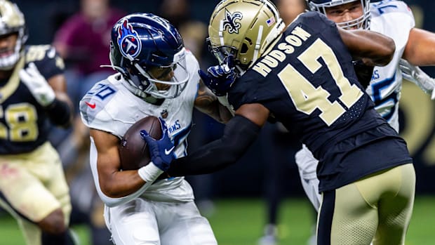 Tennessee Titans running back Tony Pollard (20) attempts to evade New Orleans Saints linebacker Khaleke Hudson (47)