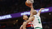 Nov 22, 2024; Washington, District of Columbia, USA; Washington Wizards guard Malcolm Brogdon (15) shoots the ball as Boston Celtics guard Derrick White (9) and Celtics forward Sam Hauser (30) defend in the second half at Capital One Arena. Mandatory Credit: Geoff Burke-Imagn Images
