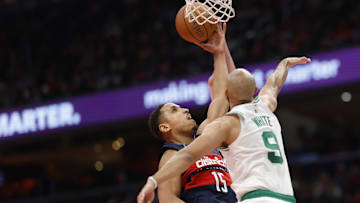 Nov 22, 2024; Washington, District of Columbia, USA; Washington Wizards guard Malcolm Brogdon (15) shoots the ball as Boston Celtics guard Derrick White (9) and Celtics forward Sam Hauser (30) defend in the second half at Capital One Arena. Mandatory Credit: Geoff Burke-Imagn Images