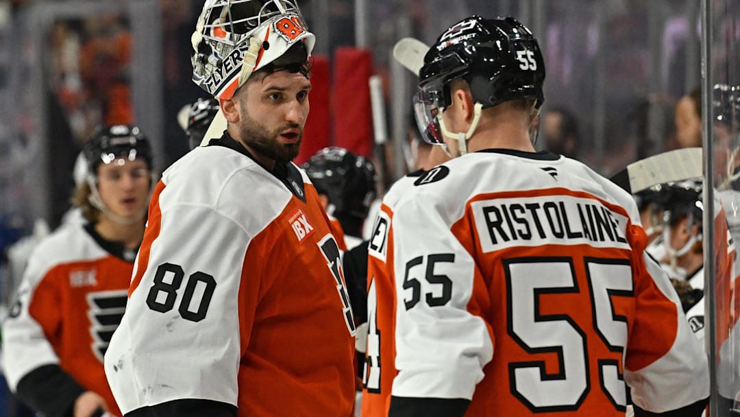 Dec 22, 2025; Philadelphia, Pennsylvania, USA; Philadelphia Flyers goaltender Dan Vladar (80) talks with  defenseman Rasmus Ristolainen (55) durijnga timeout against the Vancouver Canucks at Xfinity Mobile Arena. Mandatory Credit: Eric Hartline-Imagn Images