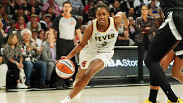 Sep 30, 2025; Las Vegas, Nevada, USA; Indiana Fever guard Kelsey Mitchell (0) dribbles against the Las Vegas Aces during the first quarter of game five of the second round of the 2025 WNBA Playoffs at Michelob Ultra Arena. Mandatory Credit: Stephen R. Sylvanie-Imagn Images