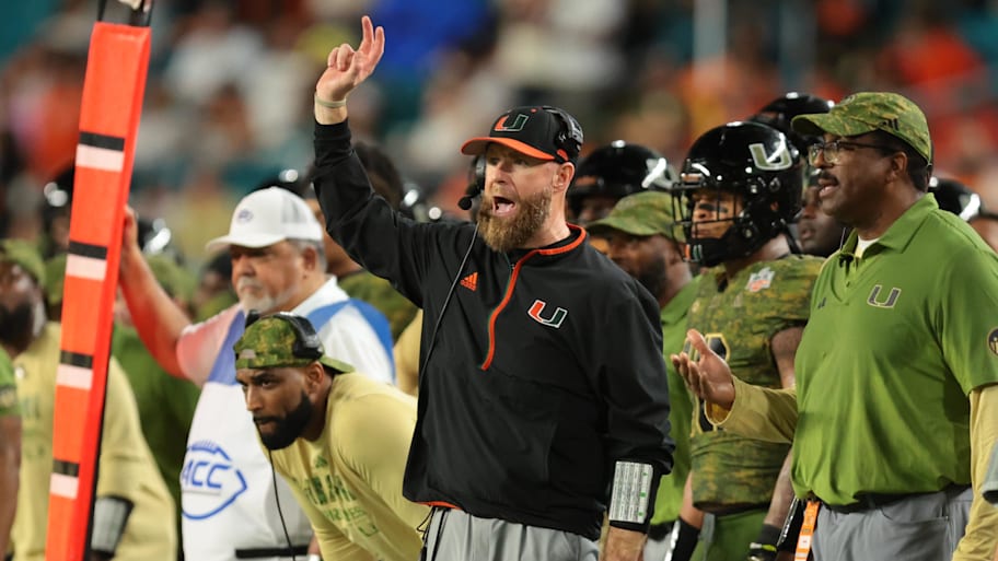 Hurricanes defensive coordinator Corey Hetherman reacts on the sideline.