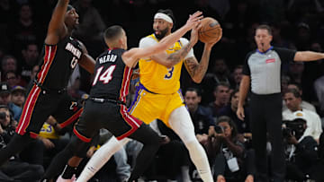 Dec 4, 2024; Miami, Florida, USA;  Los Angeles Lakers forward Anthony Davis (3) looks to pass against Miami Heat guard Tyler Herro (14) during the first half at Kaseya Center. Mandatory Credit: Jim Rassol-Imagn Images