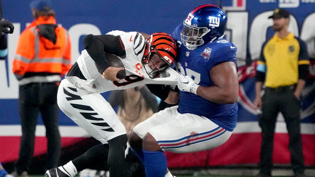 Oct 13, 2024; East Rutherford, New Jersey, USA;  Cincinnati Bengals quarterback Joe Burrow (9) is sacked by New York Giants defensive tackle Dexter Lawrence II (97) in the 3rd quarter at MetLife Stadium. Mandatory Credit: Robert Deutsch-Imagn Images