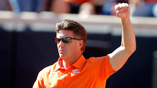 Oklahoma State coach Mike Gundy raises his fist.