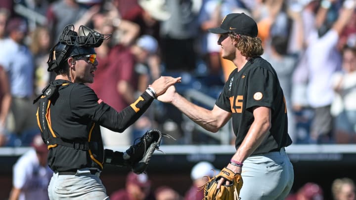 Jun 23, 2024; Omaha, NE, USA;  Tennessee Volunteers pitcher Nate Snead (7) celebrates the win with catcher Cal Stark (10) over the Texas A&M Aggies at Charles Schwab Field Omaha. Mandatory Credit: Steven Branscombe-USA TODAY Sports
