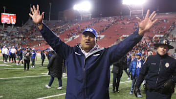 Kalani Sitake celebrates a Holy War victory with the fans.