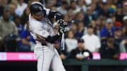 Sep 23, 2025; Seattle, Washington, USA; Colorado Rockies third baseman Kyle Karros (12) hits an RBI-infield single against the Seattle Mariners during the second inning at T-Mobile Park. 