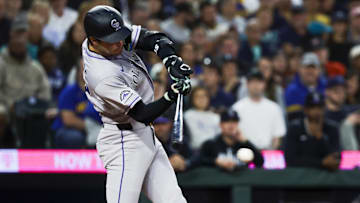 Sep 23, 2025; Seattle, Washington, USA; Colorado Rockies third baseman Kyle Karros (12) hits an RBI-infield single against the Seattle Mariners during the second inning at T-Mobile Park. 
